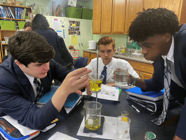 Redeemer Rhetoric School Boys participating in science experiments with beaker